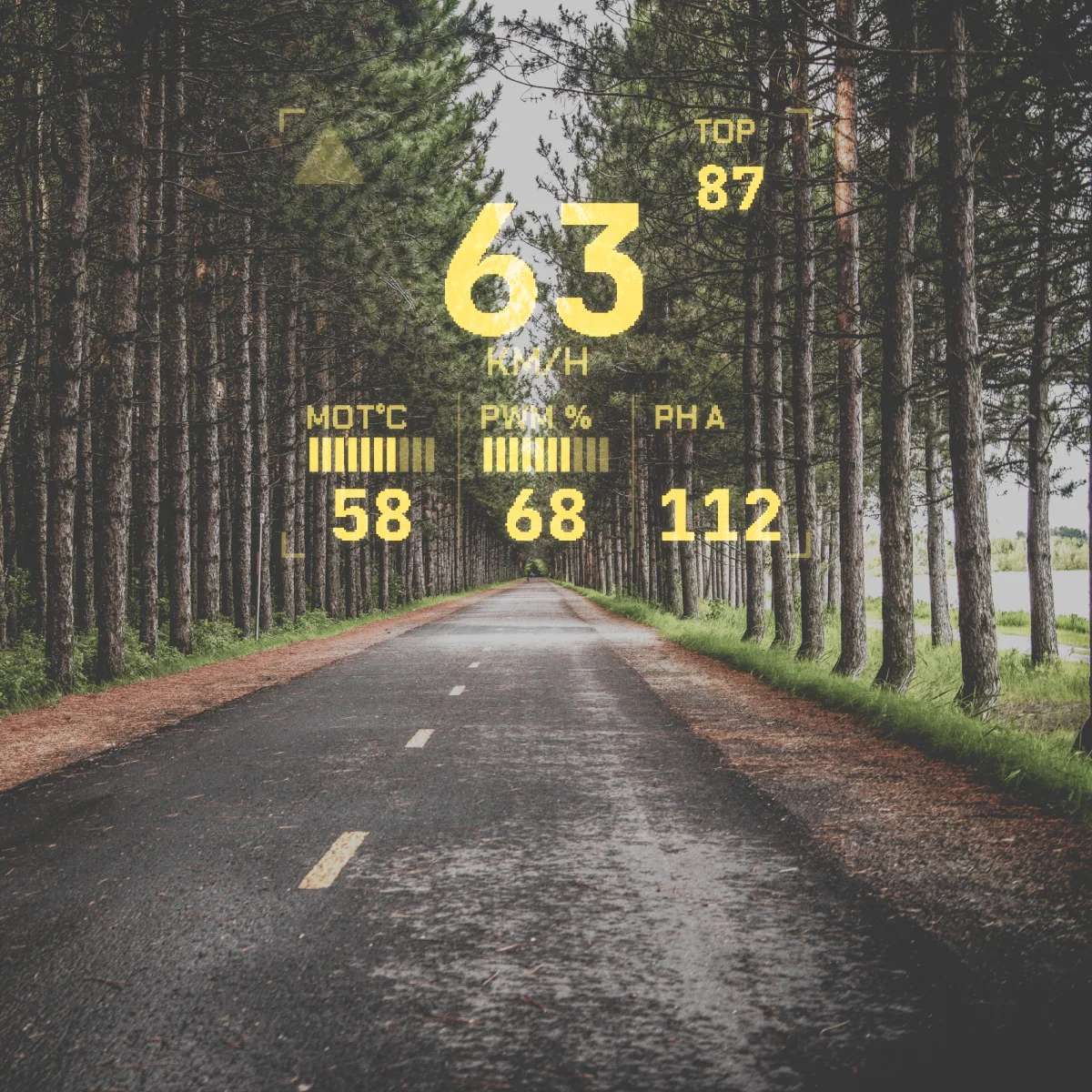 Through ENGO glasses: the WheelDash racing page with speed, top speed, motor temperature, PWM and phase current over a tree-lined road