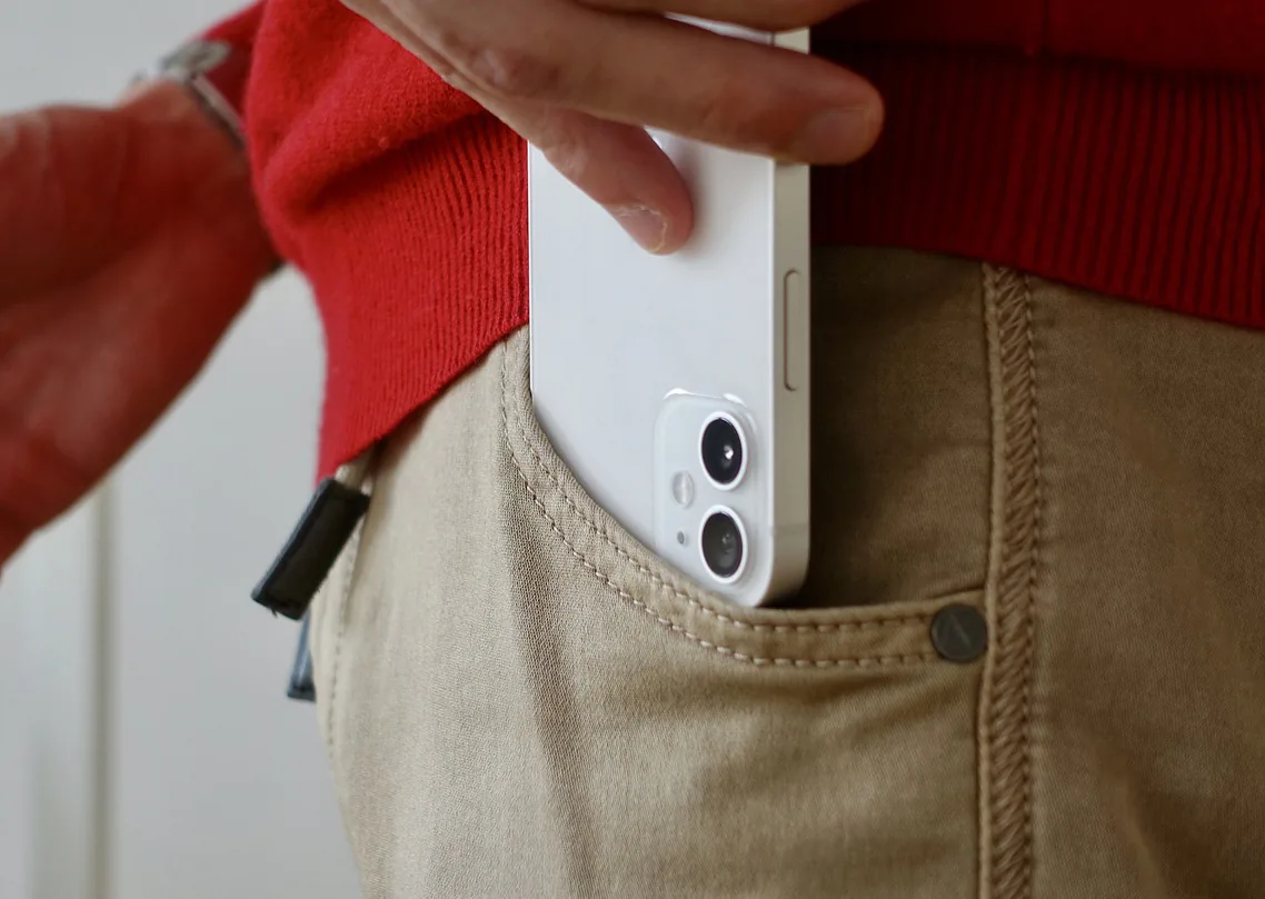A rider putting a phone into a pocket before riding