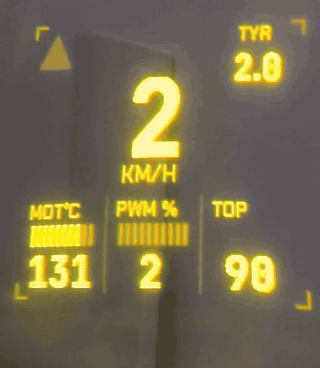 Animated WheelDash Racing view on ENGO smart glasses, showing live speed, motor temperature, PWM and tyre pressure as an alarm banner appears